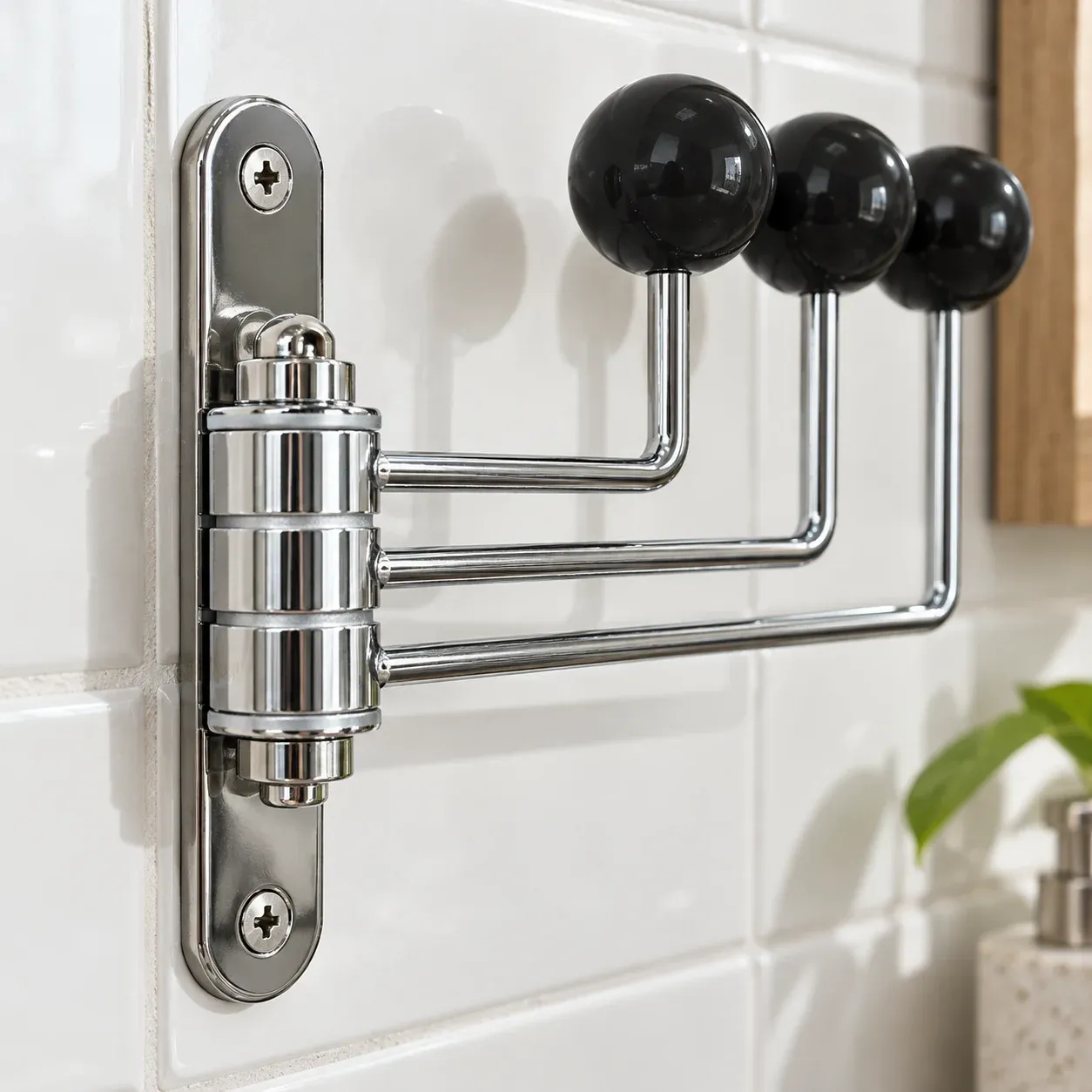 Close view of the three pivoting arms and wall mounting plate